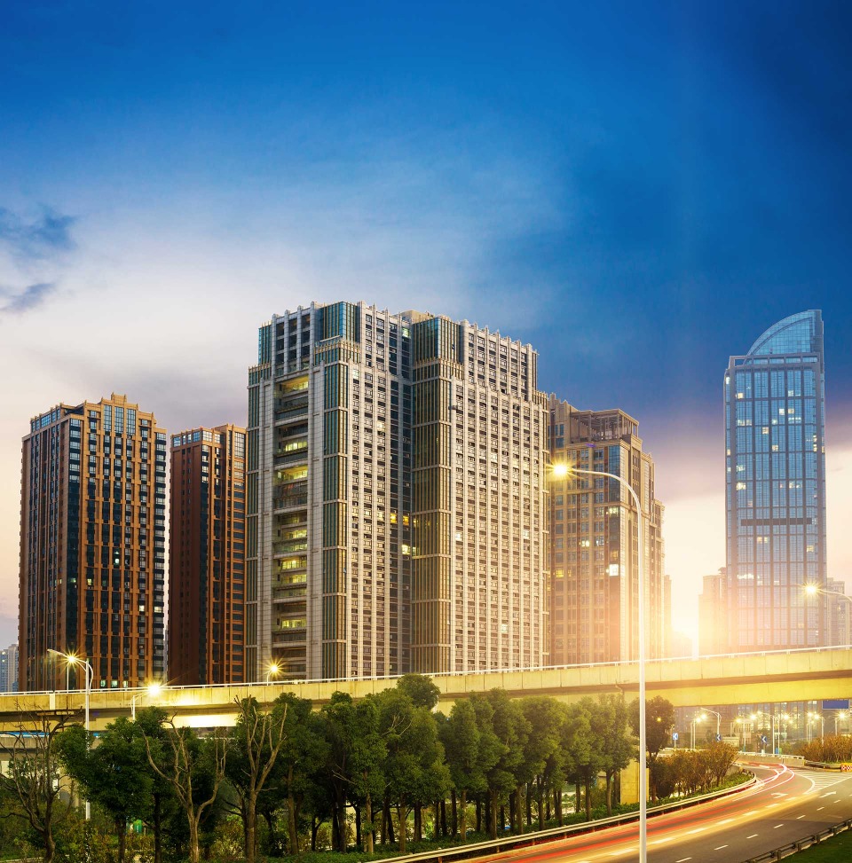 Modern city buildings under a blue sky.