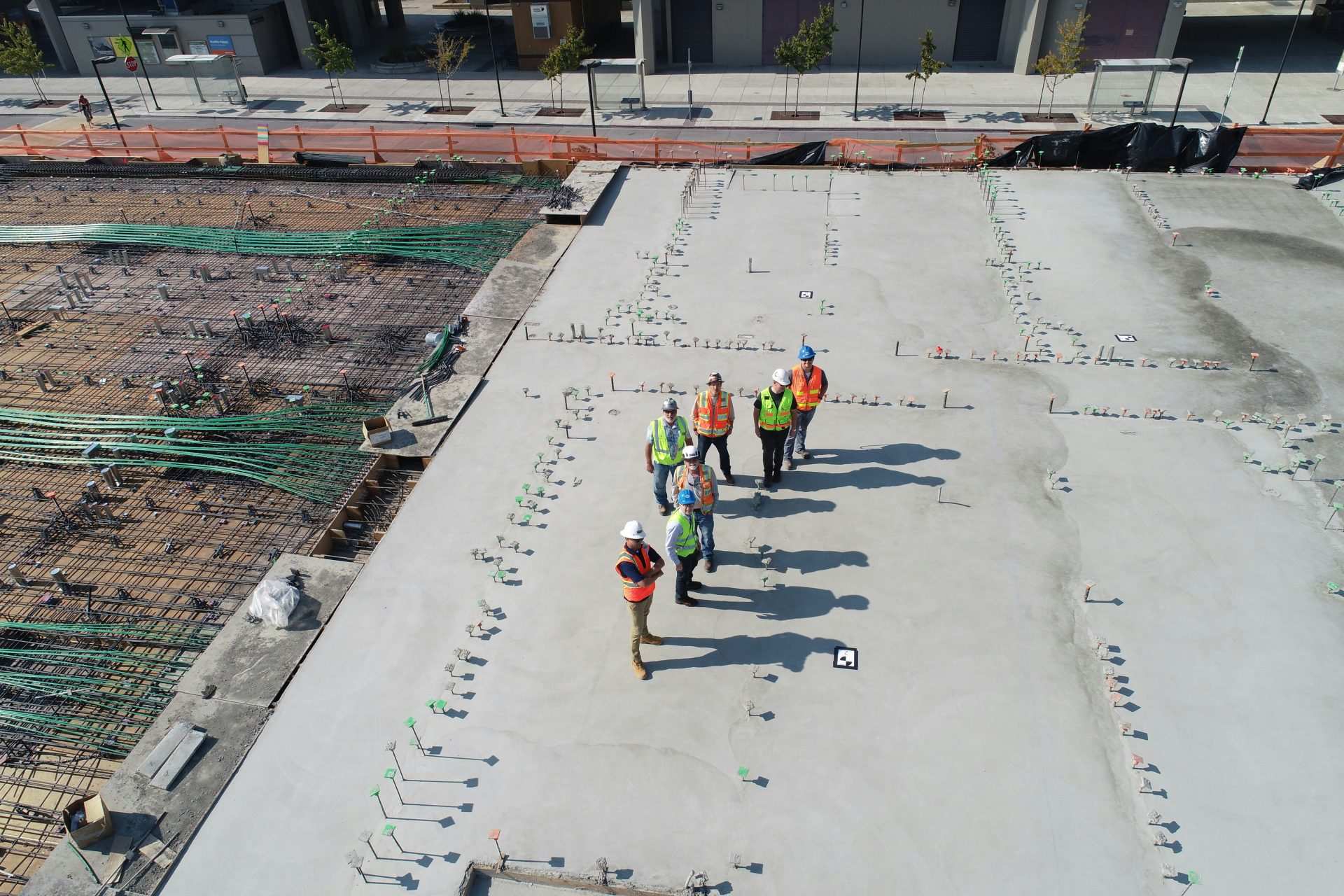 Construction workers inspecting concrete construction site.