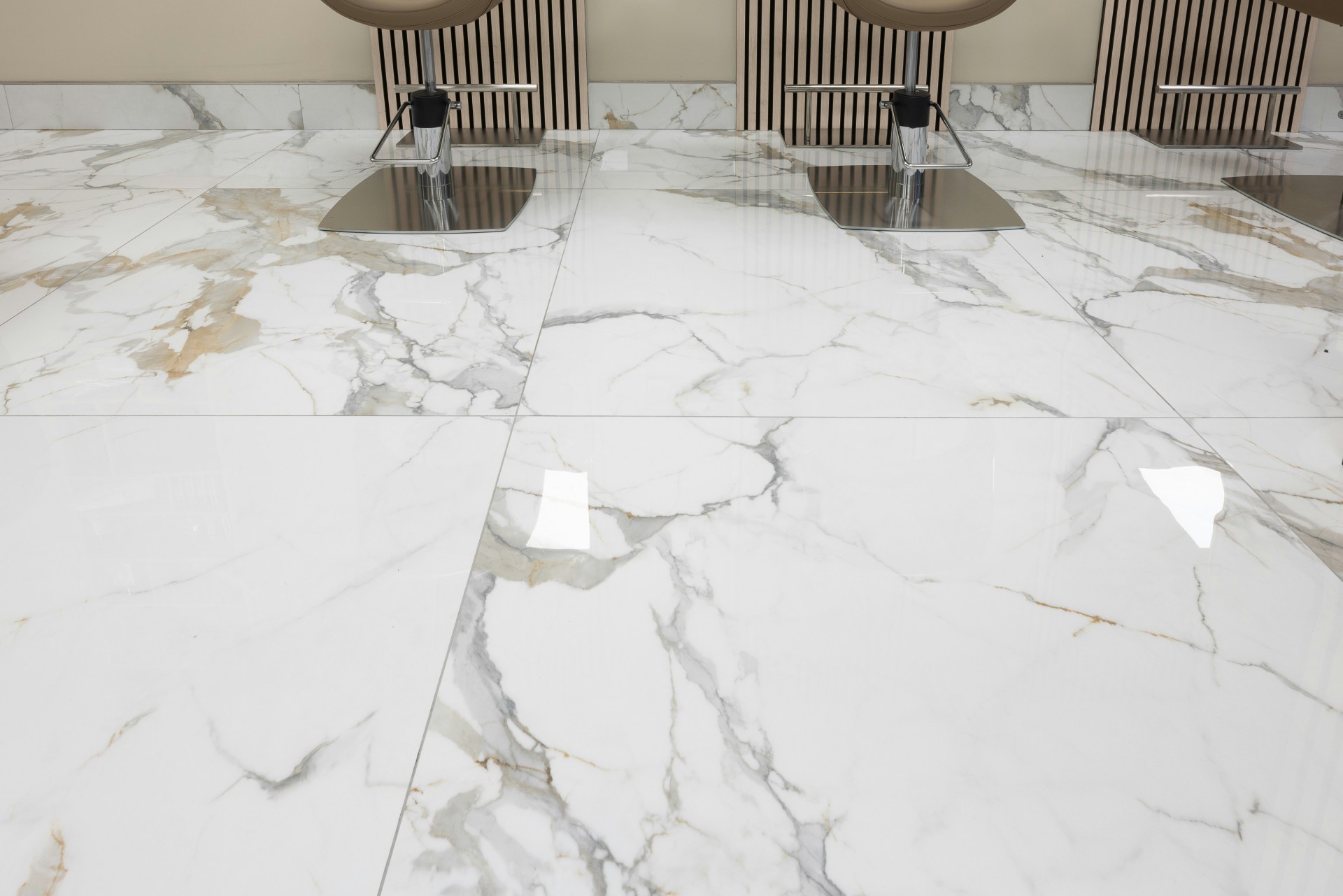 White marble floor with chairs in background.